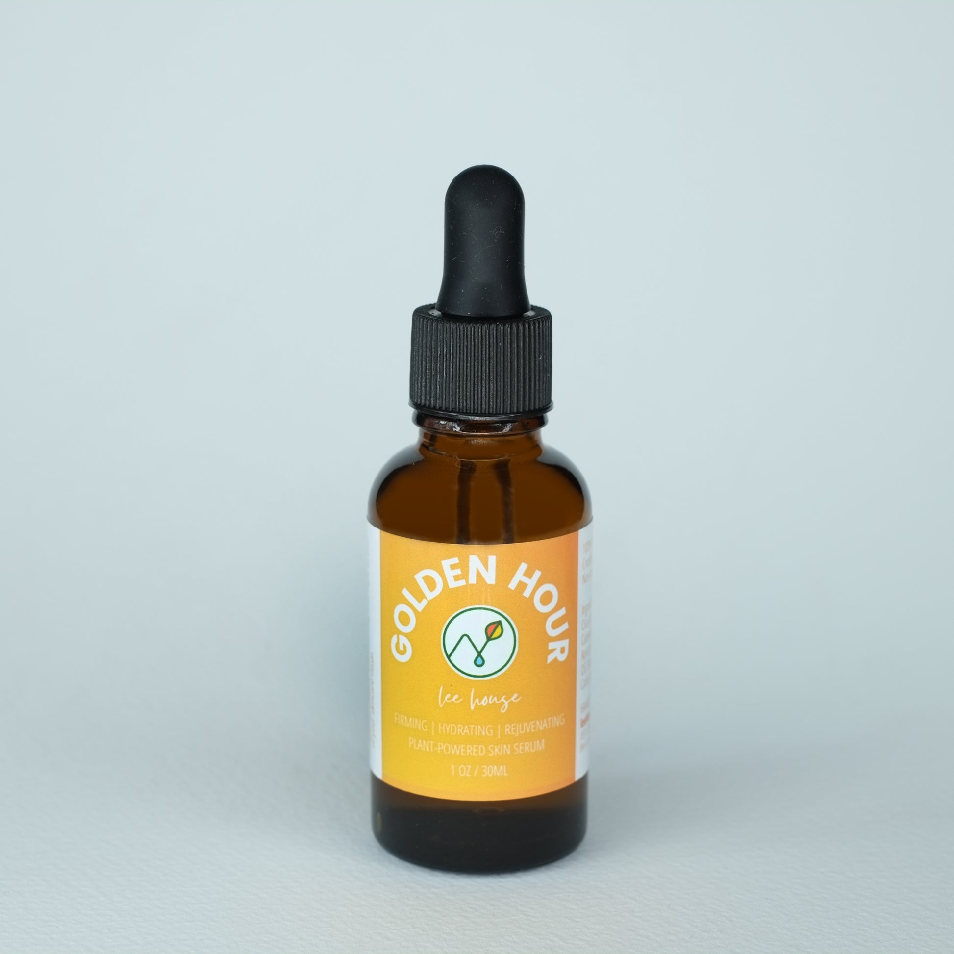 an amber dropper bottle with a yellow label reads "golden hour" by leehouse