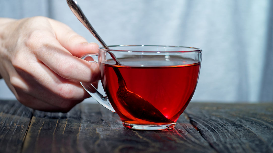 a cup of bladder support tea held in a person's hand
