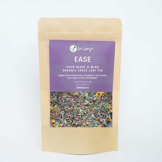 Ease herbal tea packaging with visible colorful dried herbs through a clear window. Purple label lists organic ingredients, handcrafted with love in Ben Lomond, CA, by leehouse.co. The overall design conveys a natural, artisanal look.