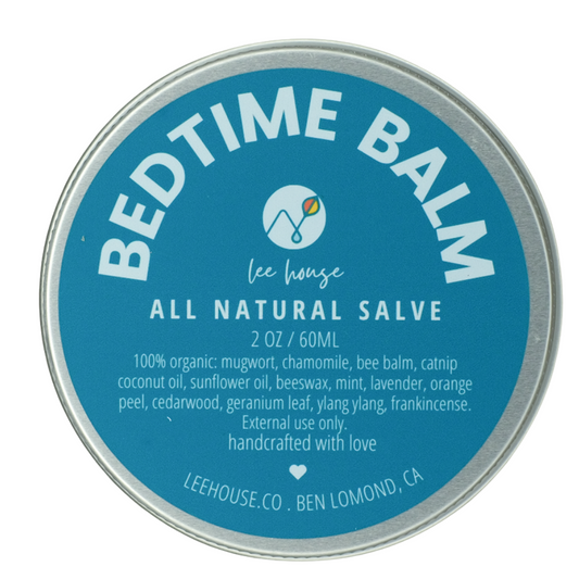 Tin of Bedtime Balm with blue label and silver rim on a white background