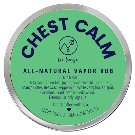 photograph of Chest Calm All-Natural Vapor Rub- photo contains a tin of salve with a minty blue label that reads: Chest Calm- all natural vapor rub. 100% Organic: Calendula, Jojoba, Sunflower Oil, Coconut Oil, Mango Butter, Beeswax, Peppermint, White Camphor, Cajaput, Cornmint,  Frankincense, Cedarwood.  External use only. Ages 6+.. handcrafted with love. leehouse.co