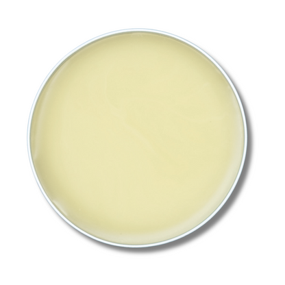 Round container of beige cream on a white background