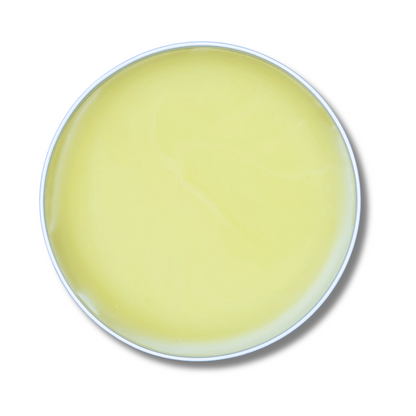 Round yellow tin of leehouse pet salve on a white background