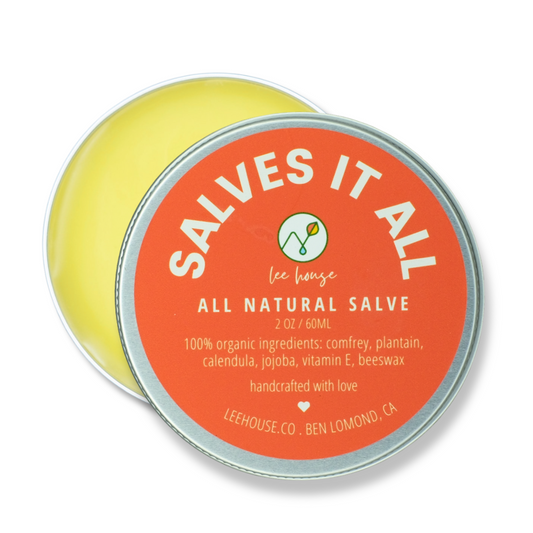 All natural salve container with orange label on a white background